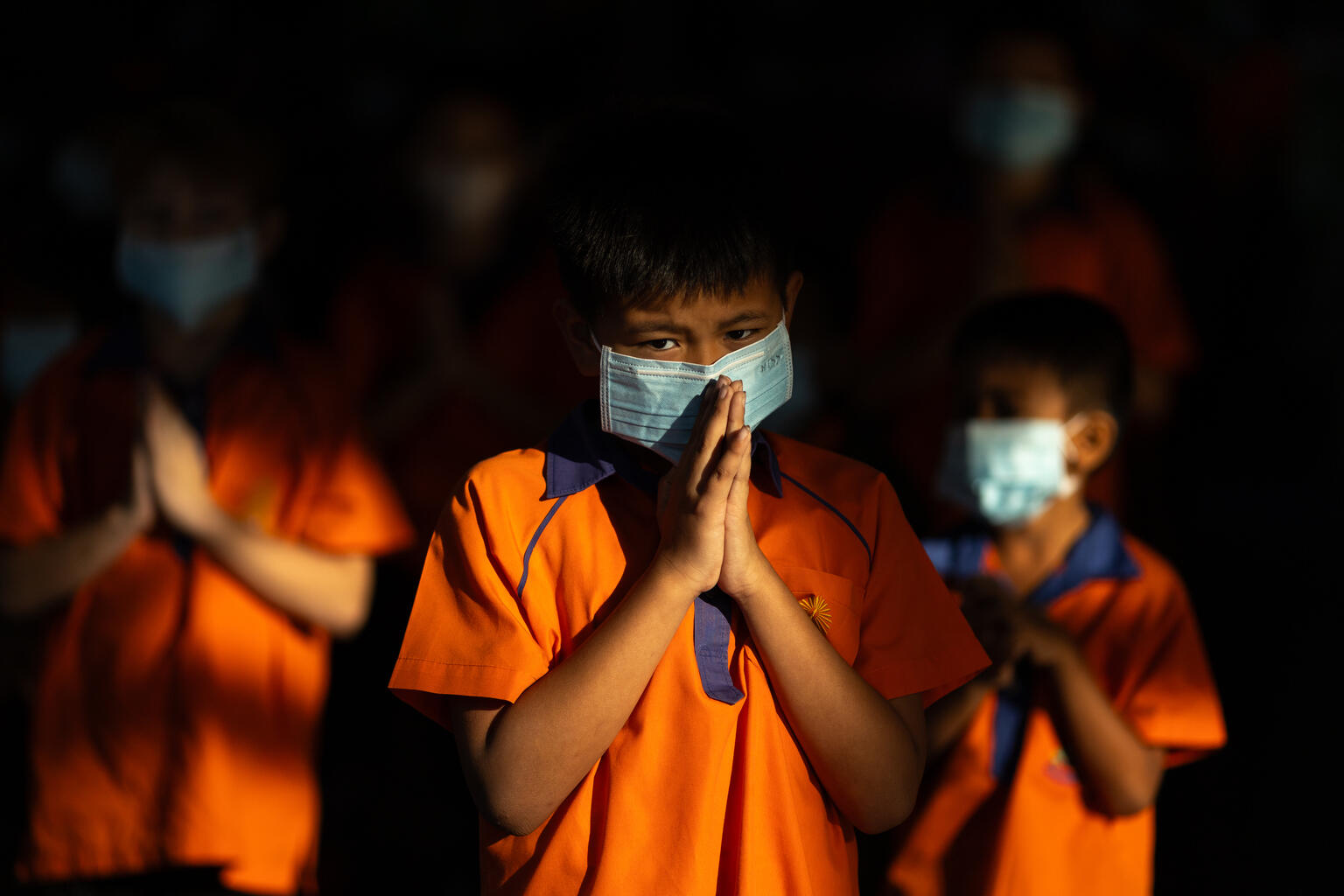 Students at Wat Wimuttayaram School, Bang Phlat District, Bangkok, wearing PM 2.5 masks while praying after air pollution checks showed levels above the standard, starting to affect health.
